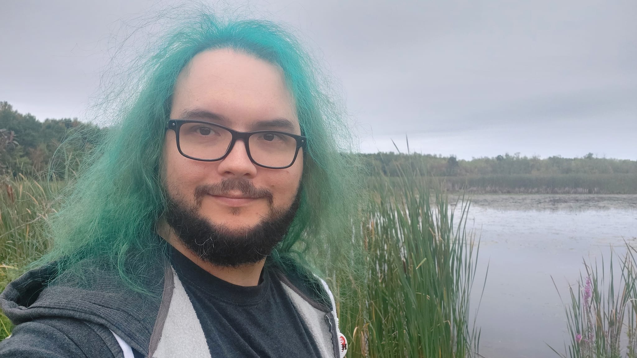 A man with green hair is visiting a freshwater marsh, photo 4